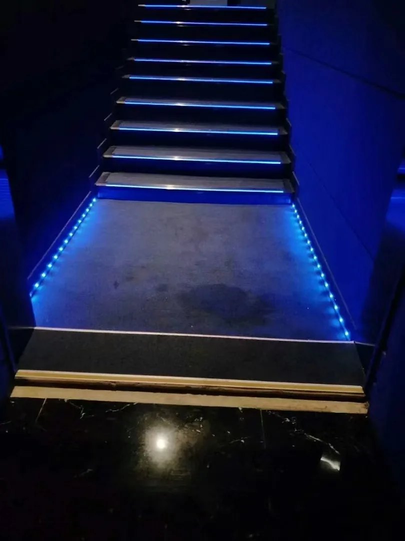 Aisle light installed along cinema aisle wall